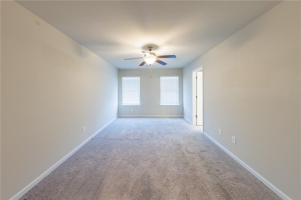 3375 Highbury Way Lithonia, GA 30038 - Photo 10 of 21 en empty room with a ceiling fan and window