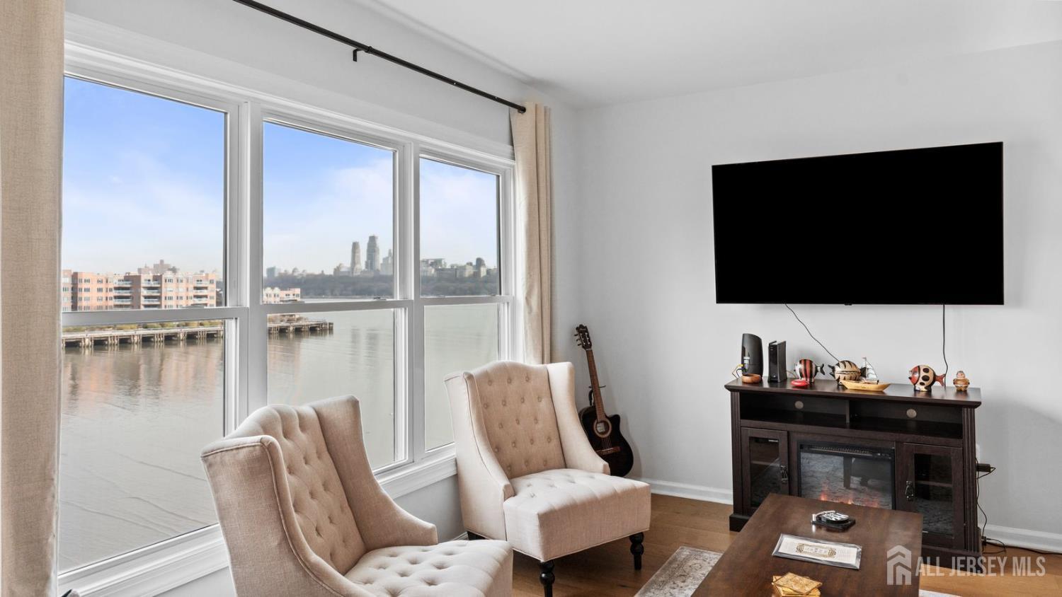 344 The Promenade Edgewater, NJ 07020 - Photo 12 of 44 a living room with furniture and a flat screen tv