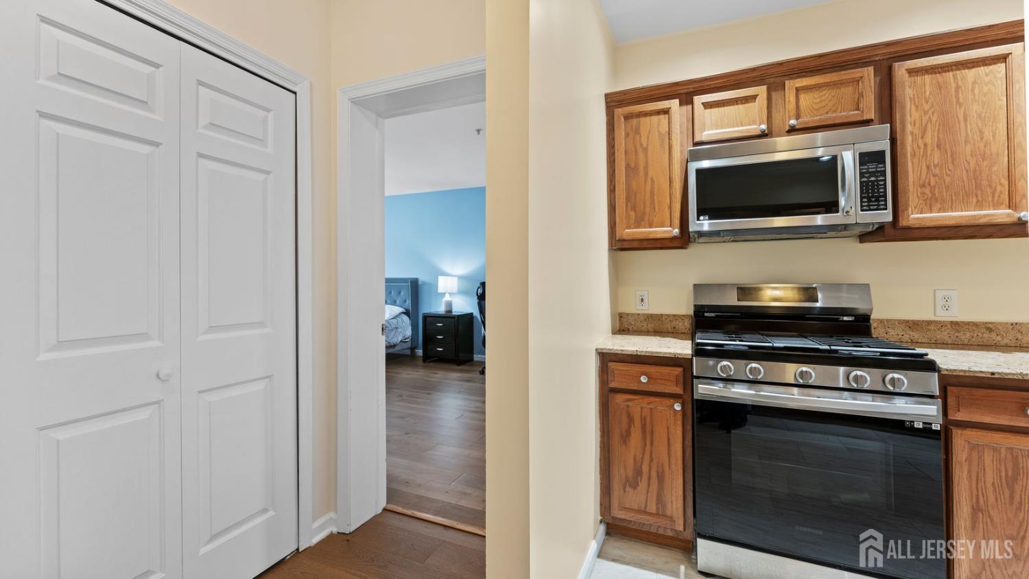 344 The Promenade Edgewater, NJ 07020 - Photo 16 of 44 a kitchen with stainless steel appliances a stove microwave and sink
