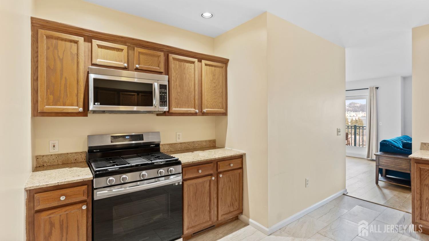 344 The Promenade Edgewater, NJ 07020 - Photo 18 of 44 a kitchen with stainless steel appliances a stove microwave and cabinets