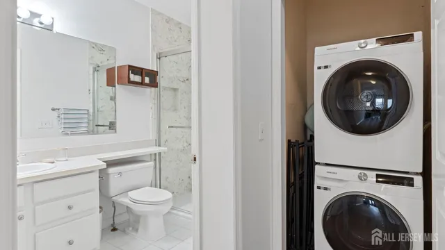 a bedroom with a bed and a dresser with wooden floor