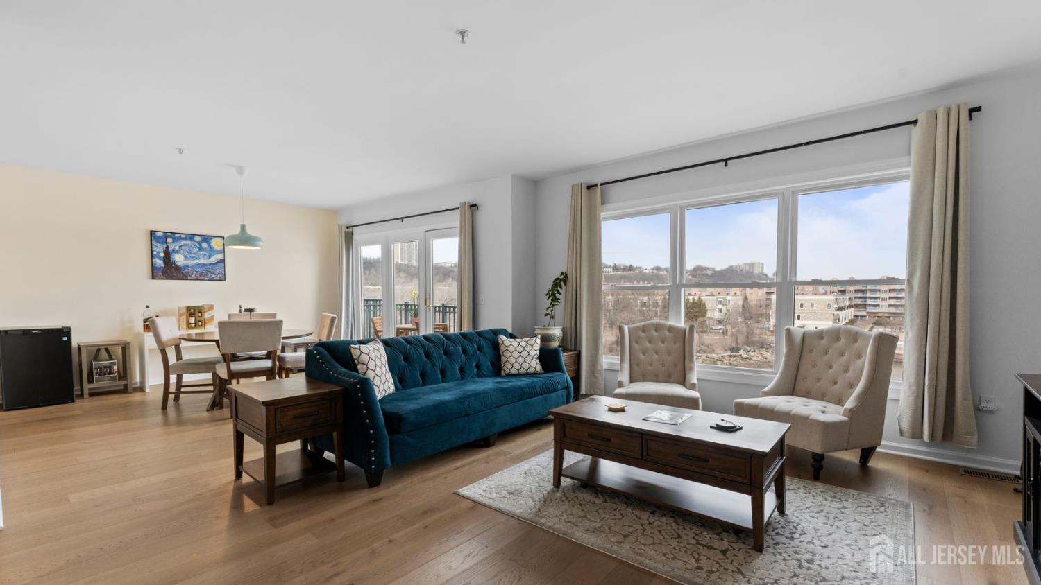344 The Promenade Edgewater, NJ 07020 - Photo 2 of 44 a living room with furniture and a large window