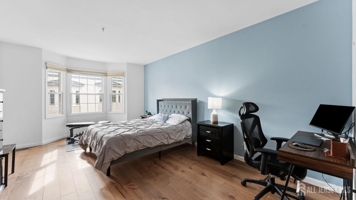 344 The Promenade Edgewater, NJ 07020 - Photo 22 of 44 a bedroom with a bed and a desk