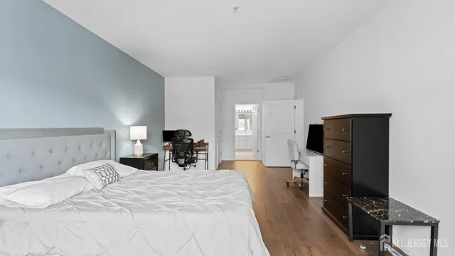 a bedroom with a bed and a dresser in it