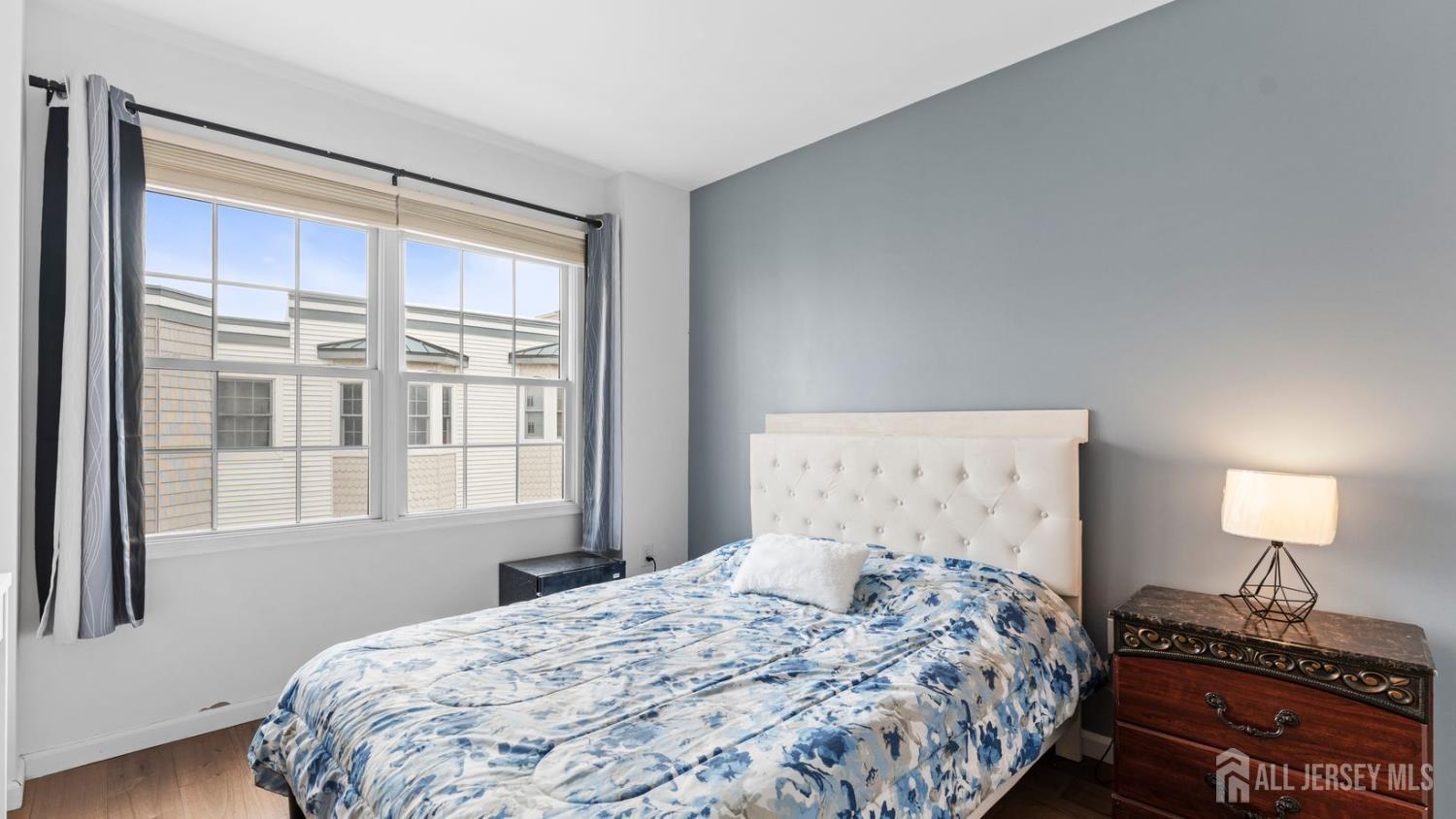 344 The Promenade Edgewater, NJ 07020 - Photo 26 of 44 a bedroom with a bed and a window