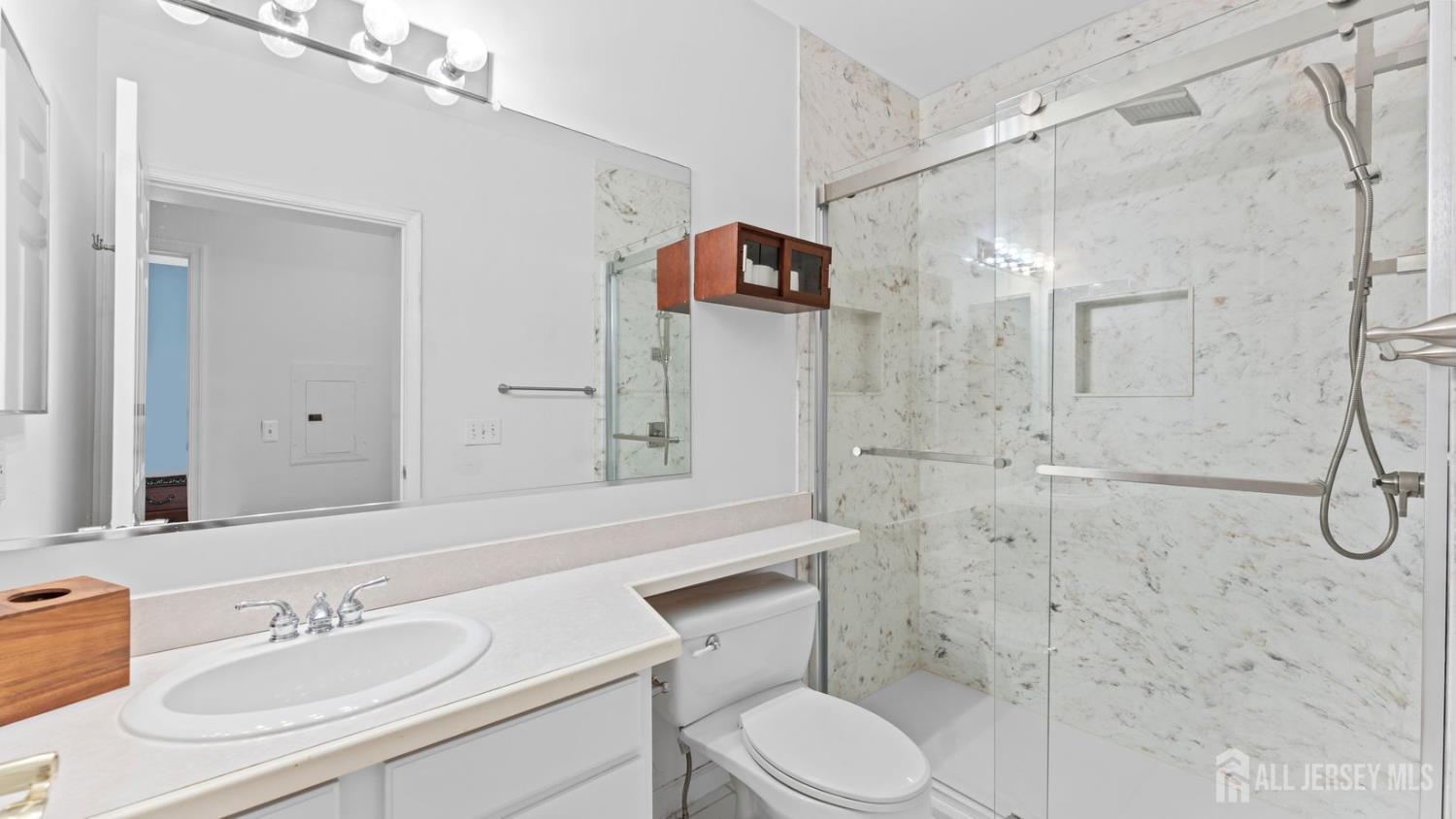 344 The Promenade Edgewater, NJ 07020 - Photo 30 of 44 a bathroom with a sink a toilet and shower