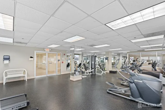 a room with gym equipment and a large window