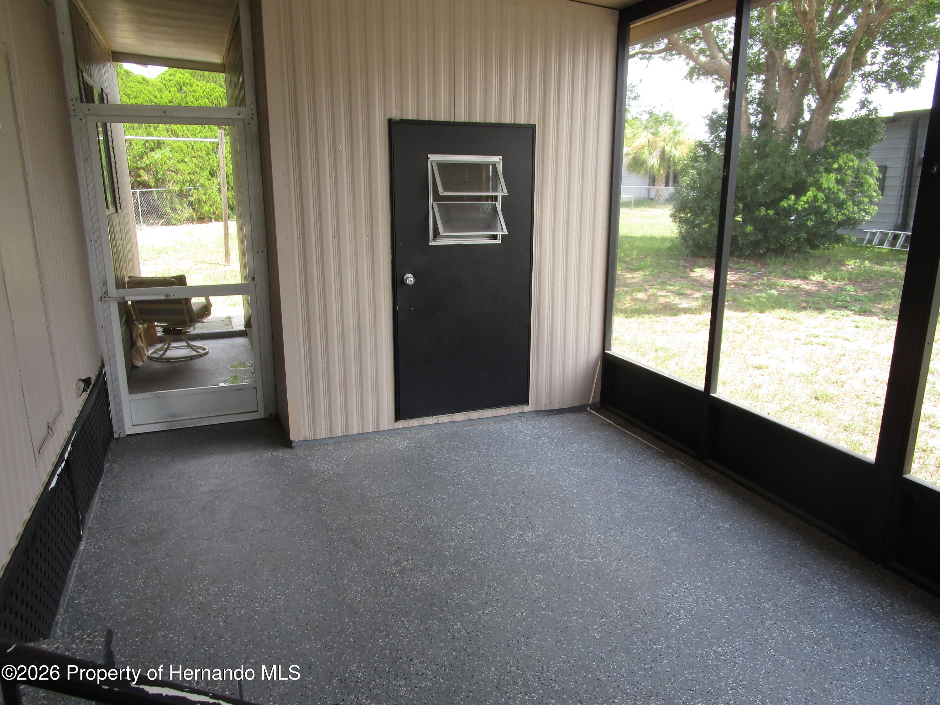 14790 Rialto Avenue, Unit 3 Brooksville, FL 34613 - Photo 14 of 15 a view of empty room with floor to ceiling window