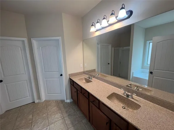 a bathroom with a sink double vanity and a mirror