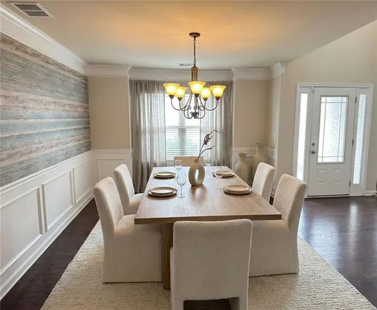 a dining room with furniture a window and wooden floor