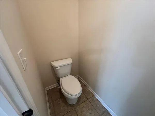 a white toilet sitting next to a white cabinet