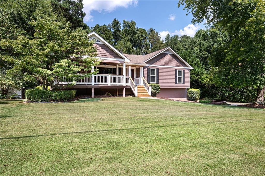 5228 Pine Way Road Powder Springs, GA 30127 - Photo 1 of 1 a front view of a house with a garden and trees