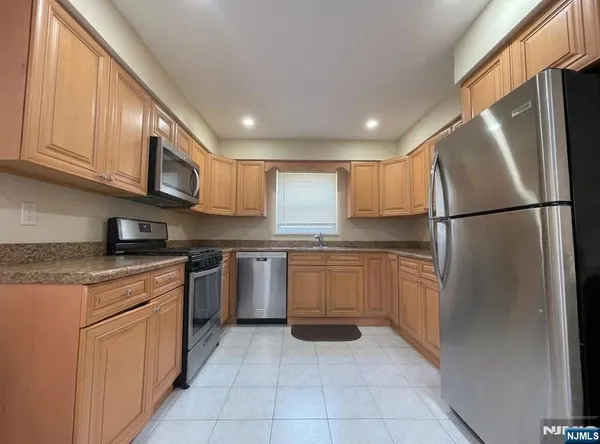 a kitchen with cabinets and chairs