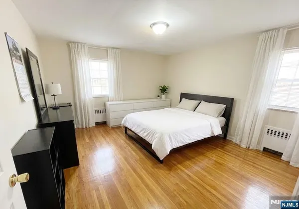 a living room with a bed furniture and a window