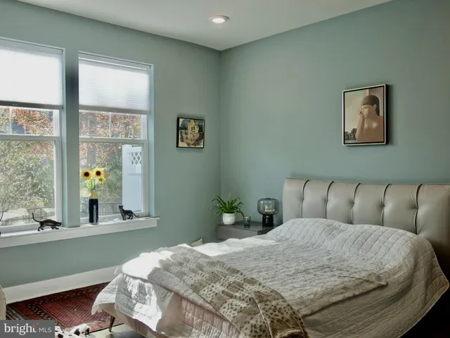a living room with a bed and a window