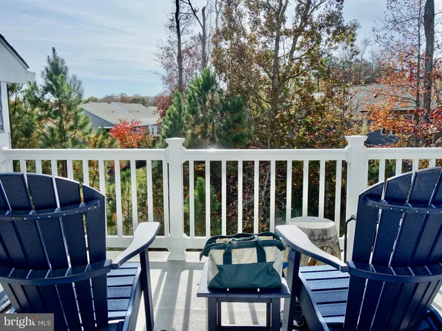 a view of a chair and table in the balcony