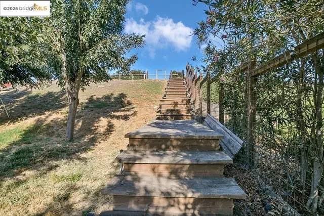 a living room with furniture and a baby crib