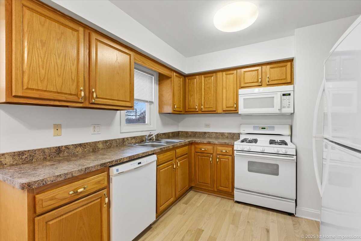7121 West 110th Street, Unit 2W Worth, IL 60482 - Photo 12 of 19 a kitchen with stainless steel appliances granite countertop a stove a sink and a microwave