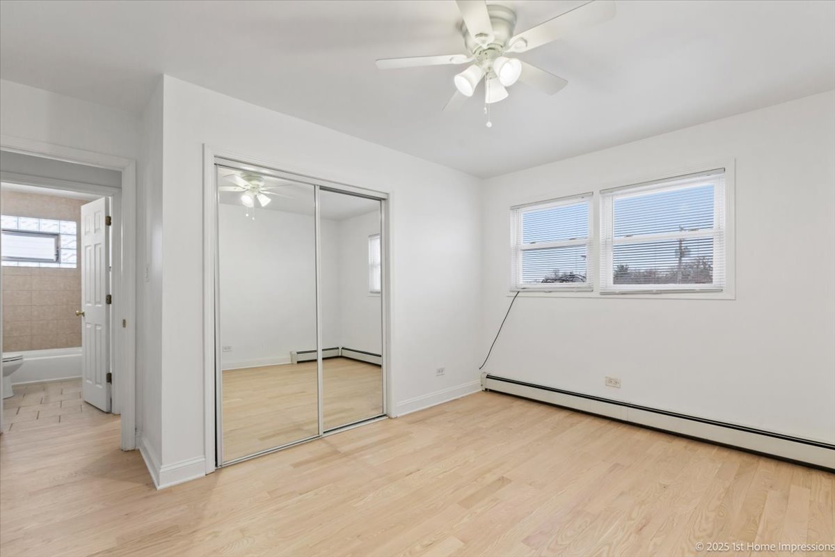 7121 West 110th Street, Unit 2W Worth, IL 60482 - Photo 18 of 19 wooden floor in an empty room with a window