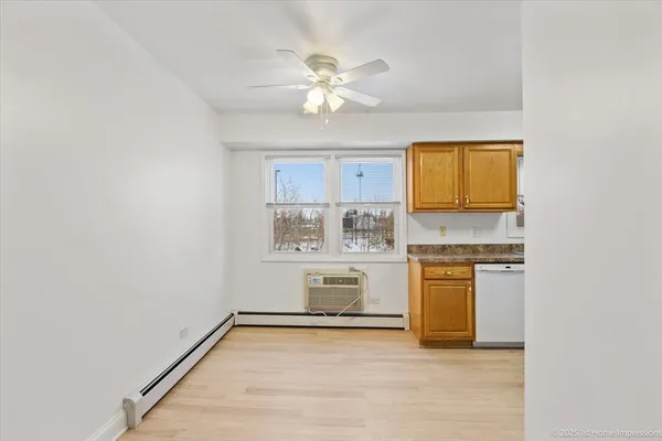 a view of kitchen with granite countertop cabinets and window
