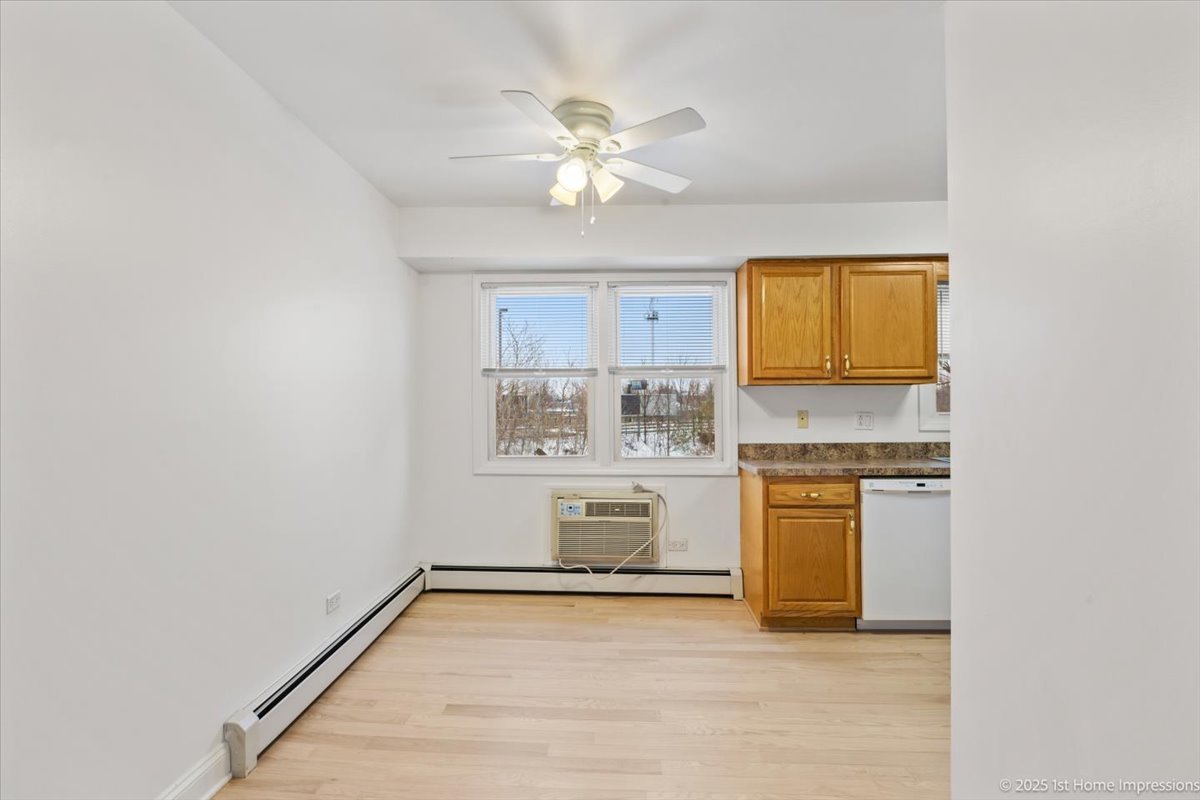 7121 West 110th Street, Unit 2W Worth, IL 60482 - Photo 7 of 19 a view of kitchen with granite countertop cabinets and window