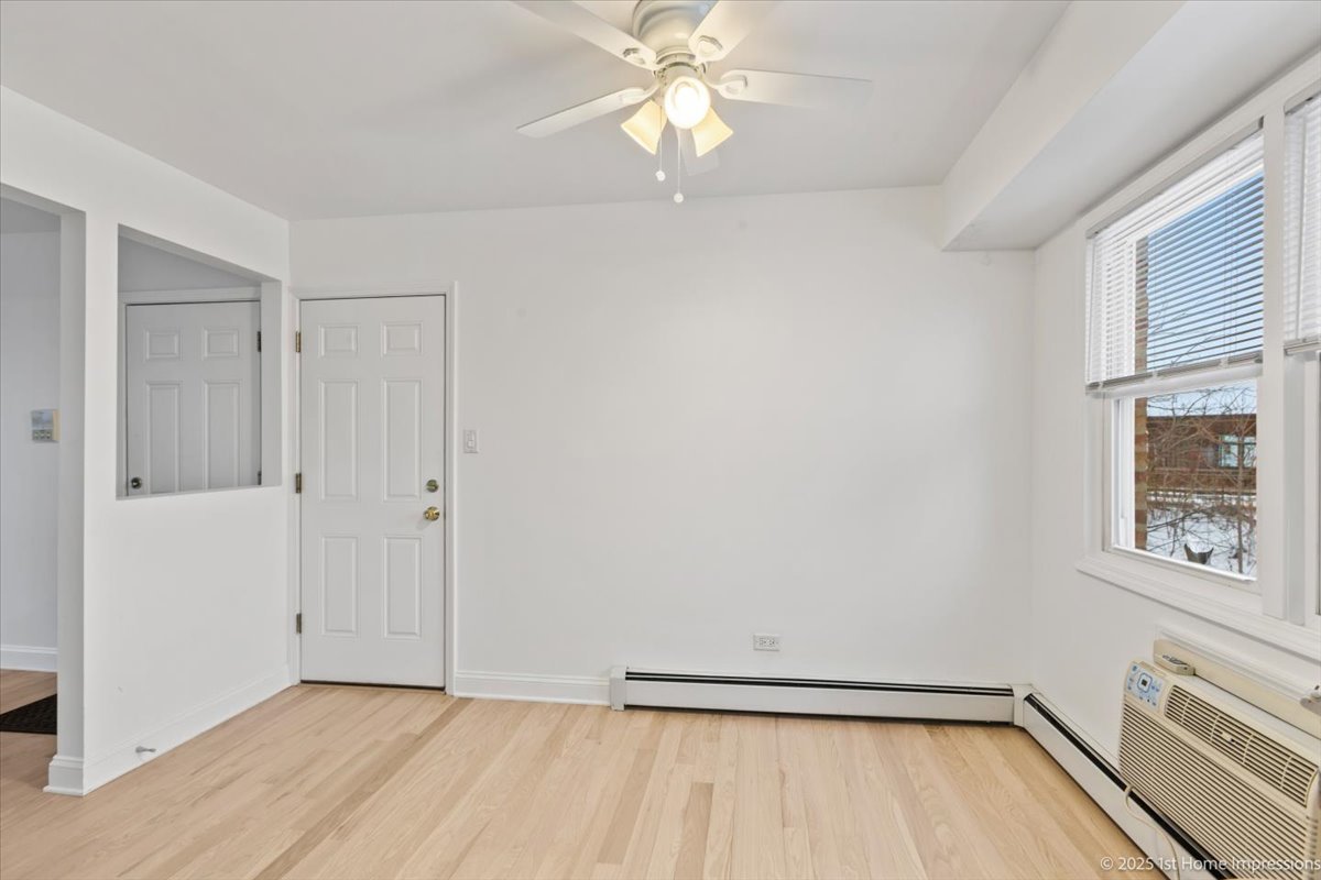 7121 West 110th Street, Unit 2W Worth, IL 60482 - Photo 9 of 19 wooden floor in an empty room with a window