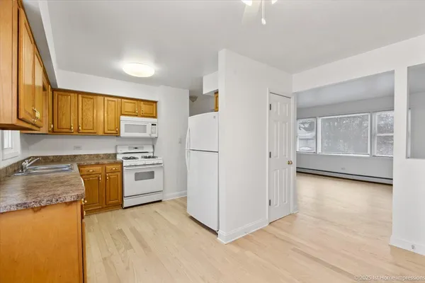 a kitchen with stainless steel appliances granite countertop a refrigerator sink and stove