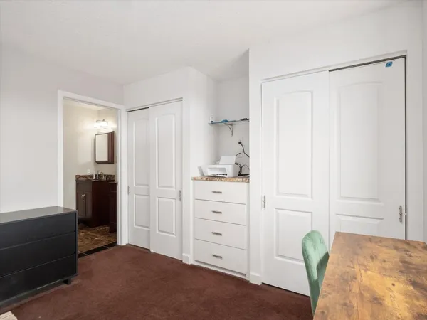 a bedroom with a bed and a walk in closet