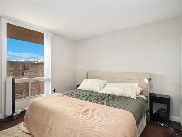 a bedroom with a large bed and a window