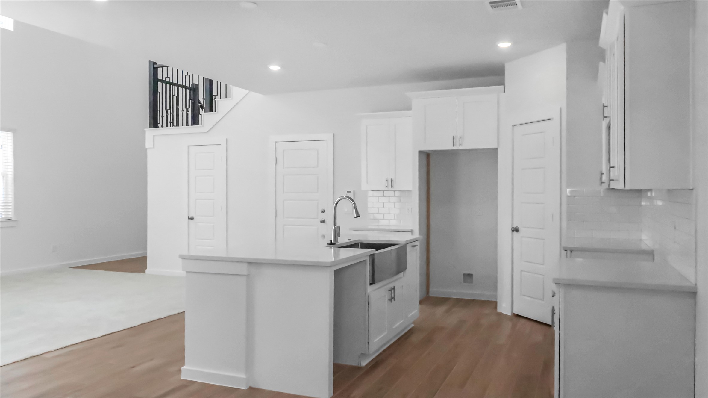 6635 Escondido Drive Rosharon, TX 77583 - Photo 12 of 28 a kitchen that has a lot of cabinets and wooden floor