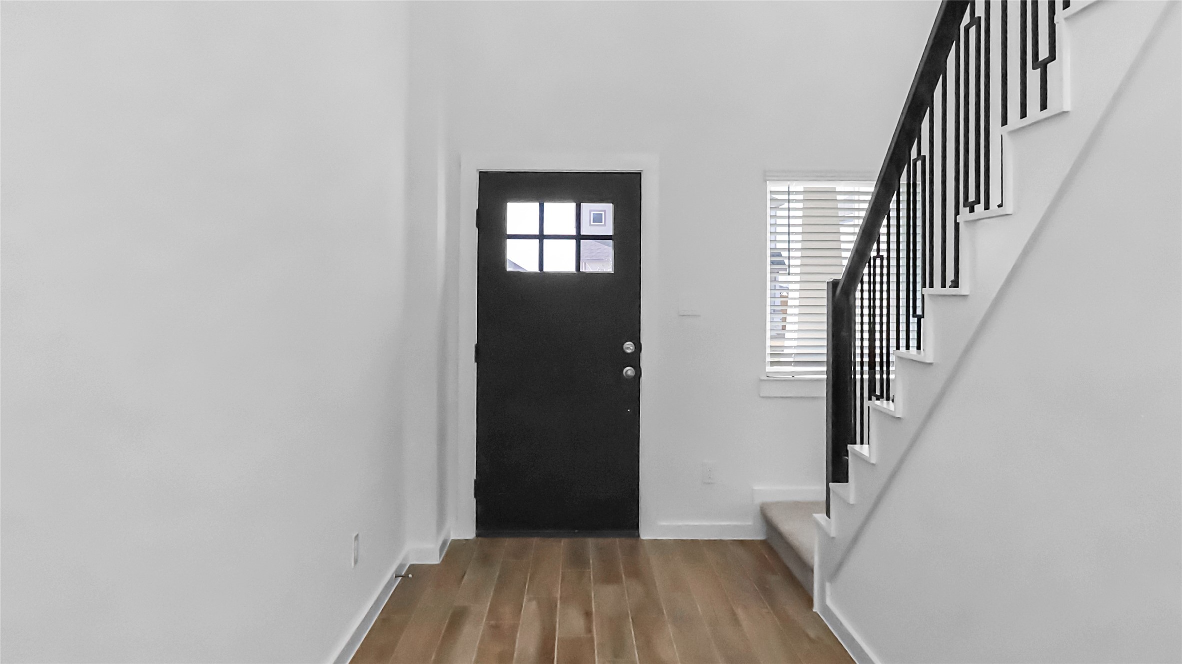 6635 Escondido Drive Rosharon, TX 77583 - Photo 6 of 28 a view of a hallway with wooden floor and staircase
