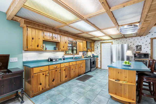 a kitchen with stainless steel appliances granite countertop a sink and cabinets