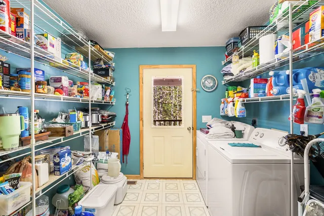 a utility room with lots of clutter and cabinets
