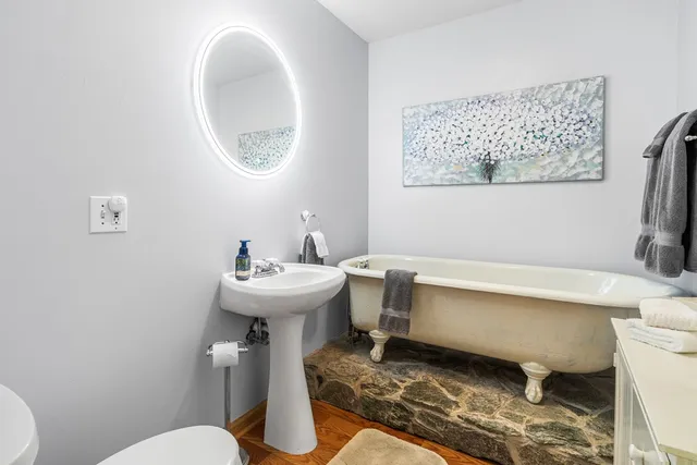 a bathroom with a sink toilet and a mirror