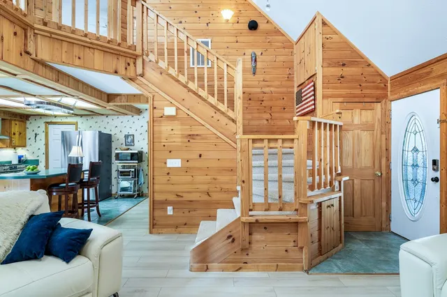 a living room with fireplace furniture and a wooden floor