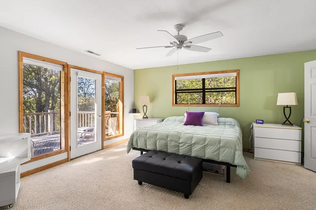 a spacious bedroom with a bed and a large window