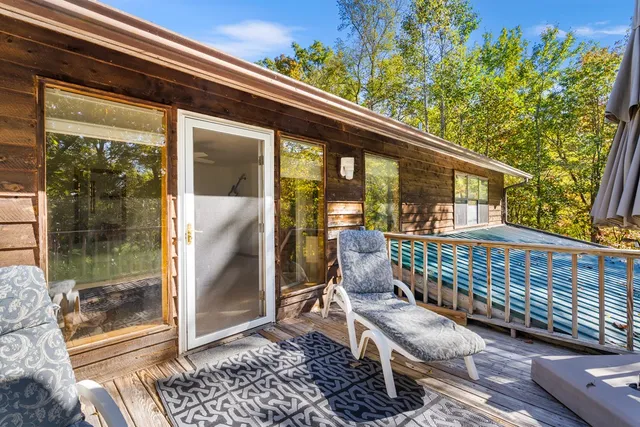 a porch with a bench next to a yard