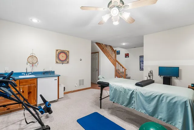 a bedroom with furniture and a wooden floor