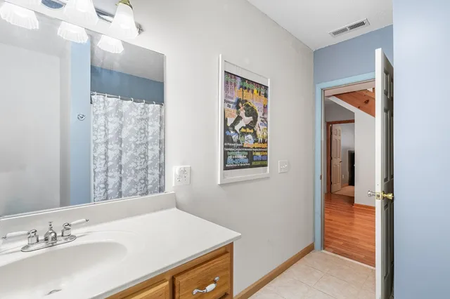 a bathroom with a sink vanity and a mirror