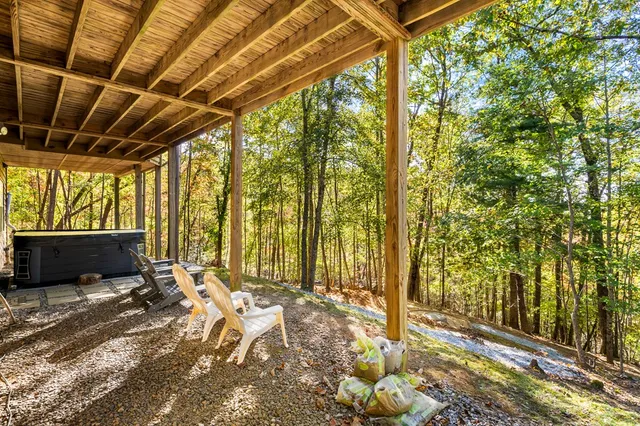 a view of a room with wooden floor and door