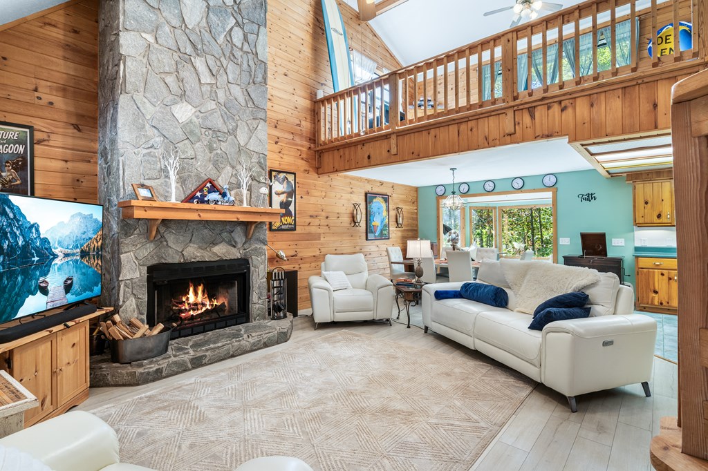 230 Pinners Point Hayesville, NC 28904 - Photo 5 of 35 a living room with furniture a fireplace and a large window