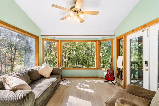 a bedroom with furniture and a large window