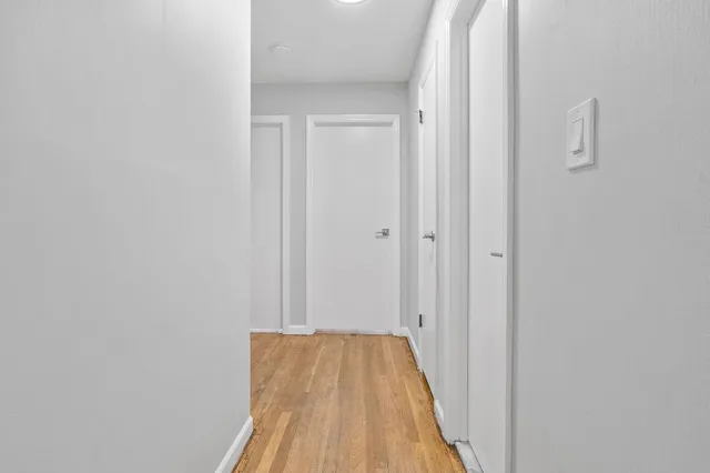 a view of a hallway with wooden floor