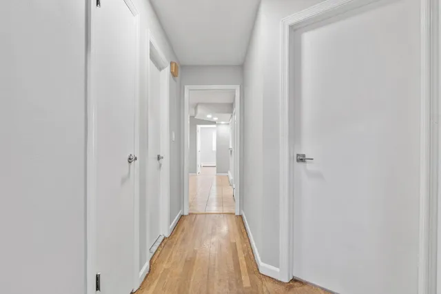 a view of a hallway with wooden floor