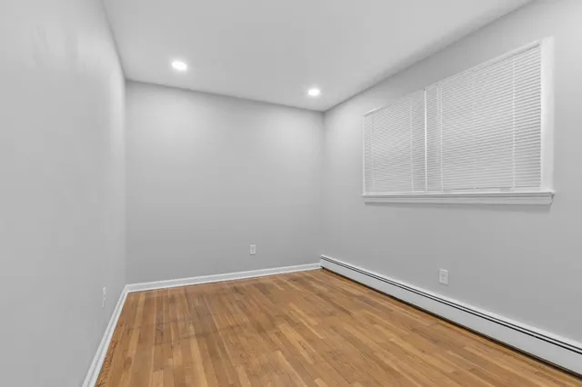 a view of room with wooden floor and cabinet