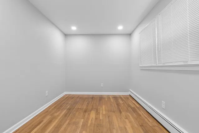 a view of room with wooden floor and fan