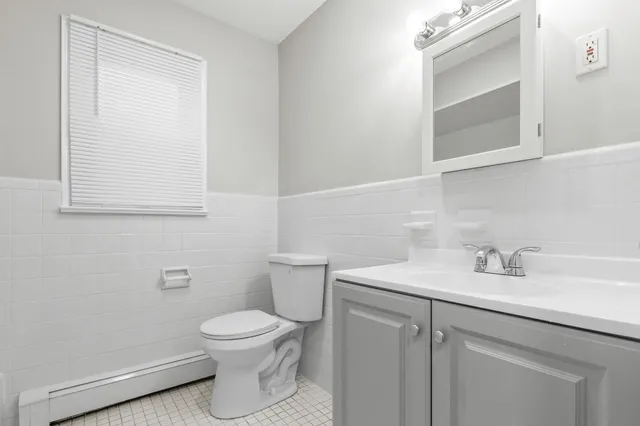 a bathroom with a sink a toilet and mirror