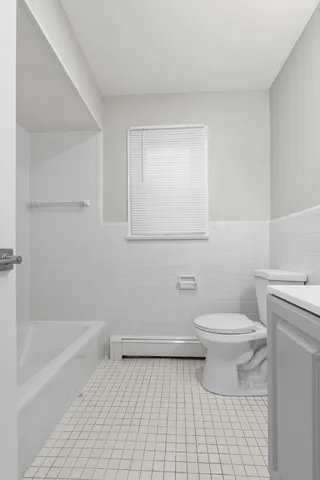 a bathroom with a toilet and a bathtub