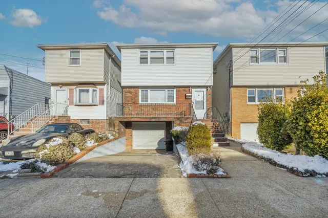 a wooden bench sitting in front of a house