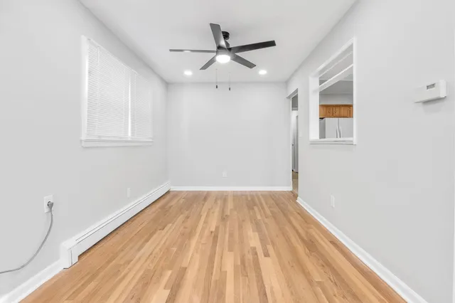 wooden floor in an empty room with a window
